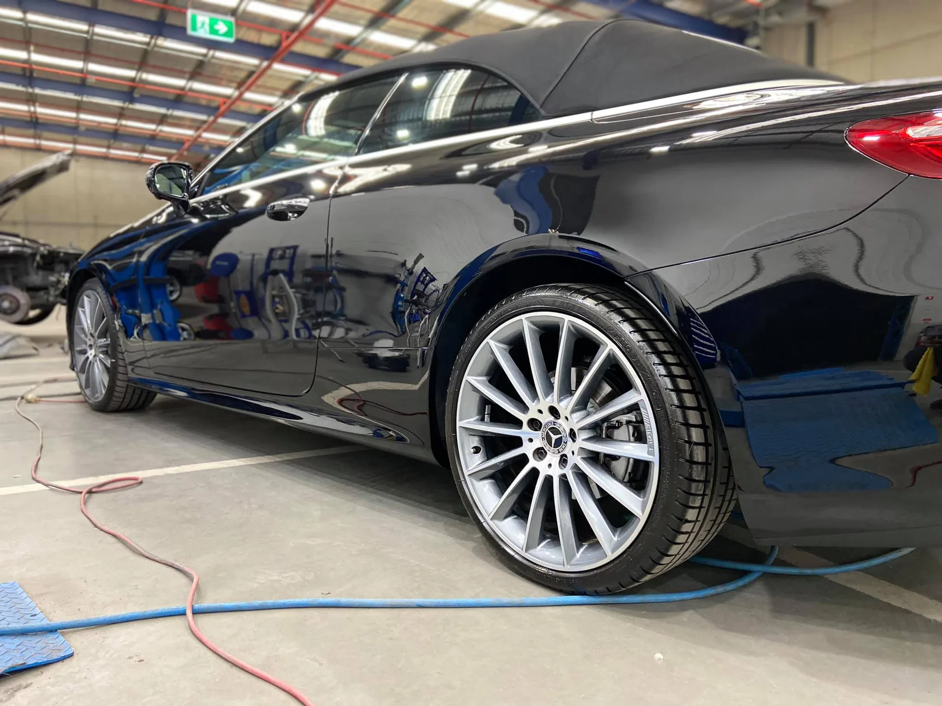 Black Mercedes coupe in the workshop